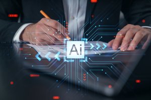 A person is working on a document at a desk. The central focus is on a glowing "AI" icon surrounded by a network of interconnected blue lights and arrows, symbolizing artificial intelligence and technology integration.