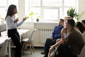 A woman explaining in front of a group of people
