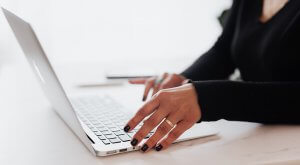 A woman navigating the internet using a laptop
