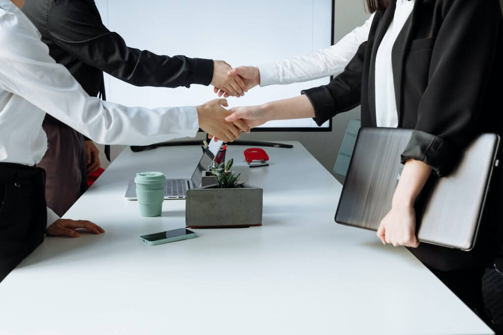 People shaking hands in an office