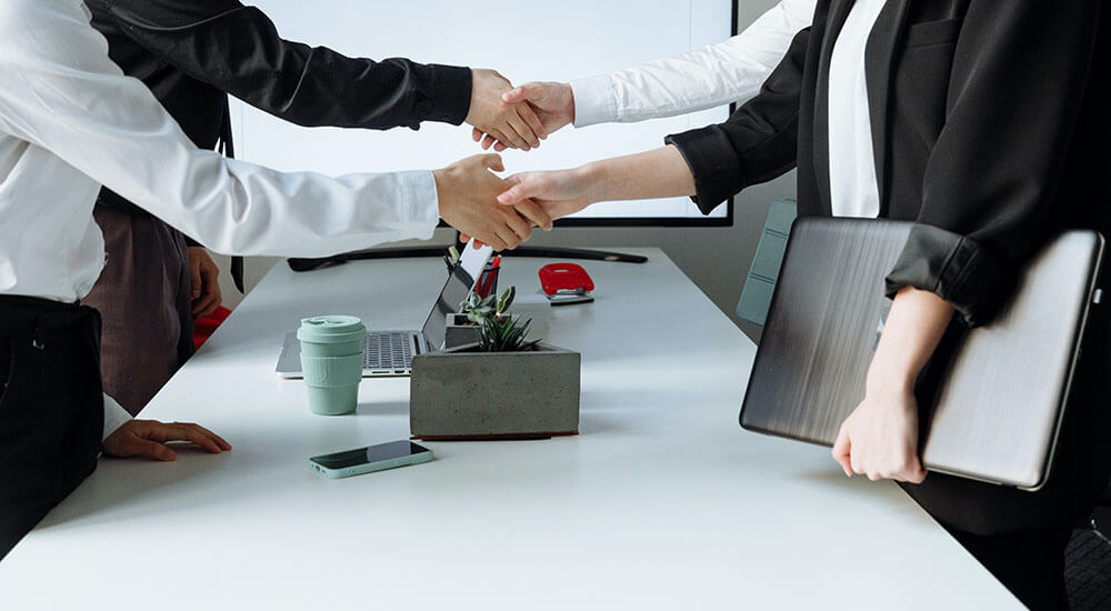 People shaking hands in an office - Richland County - Careers In Government