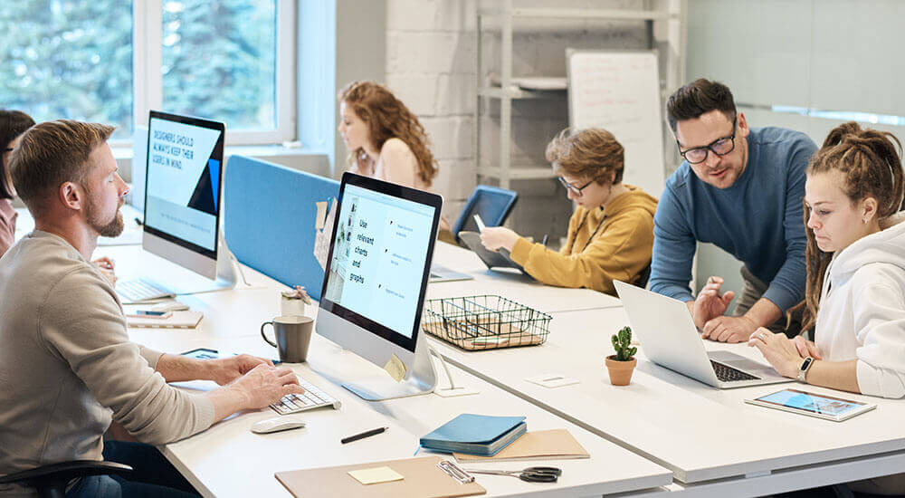 People staring at computer screens in an office - Richland County - Careers In Government