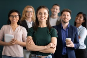 People with different Age And Ethnicity standing behind a woman
