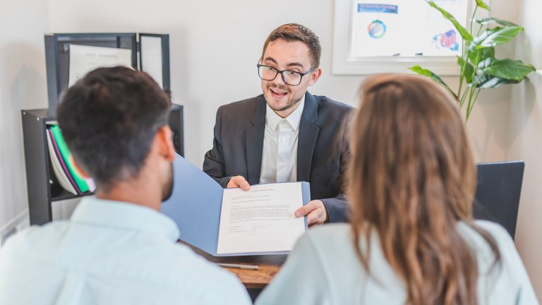 A man showing two people a book - Contract Jobs Atlanta - Careers In Government