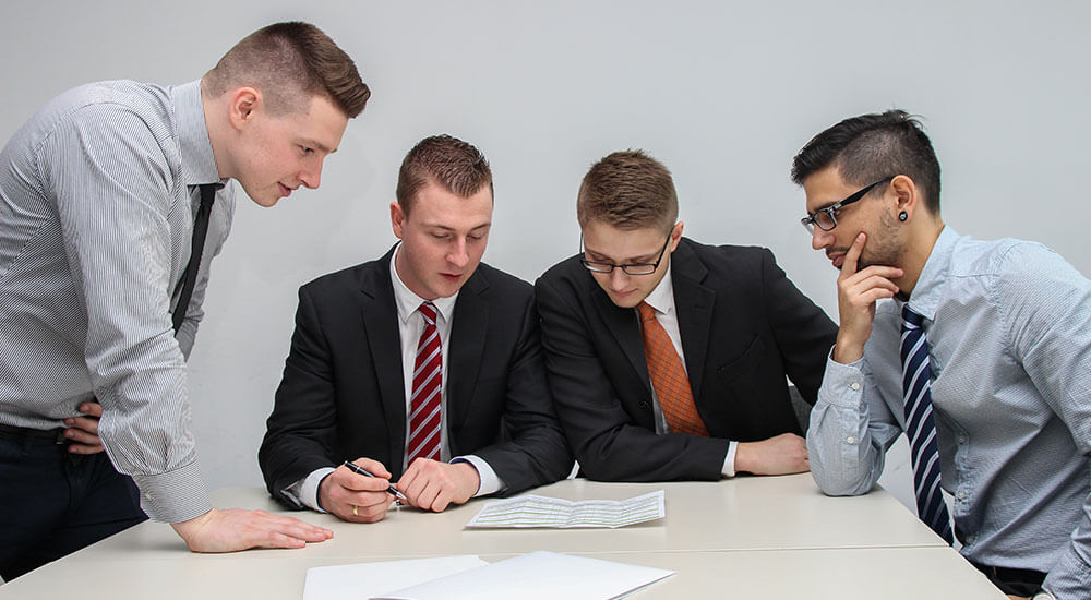 Men staring at a paper - Atlanta - Careers In Government