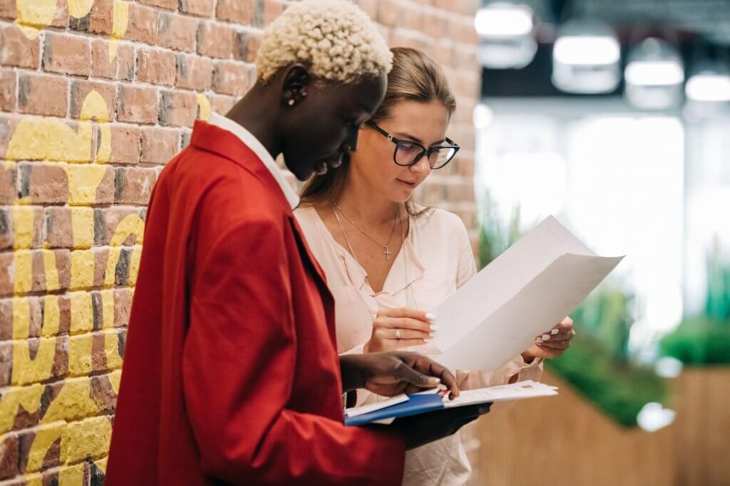 Two women holding books