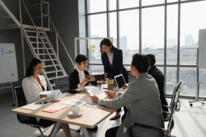 A woman presenting her analysis to young lady and the team