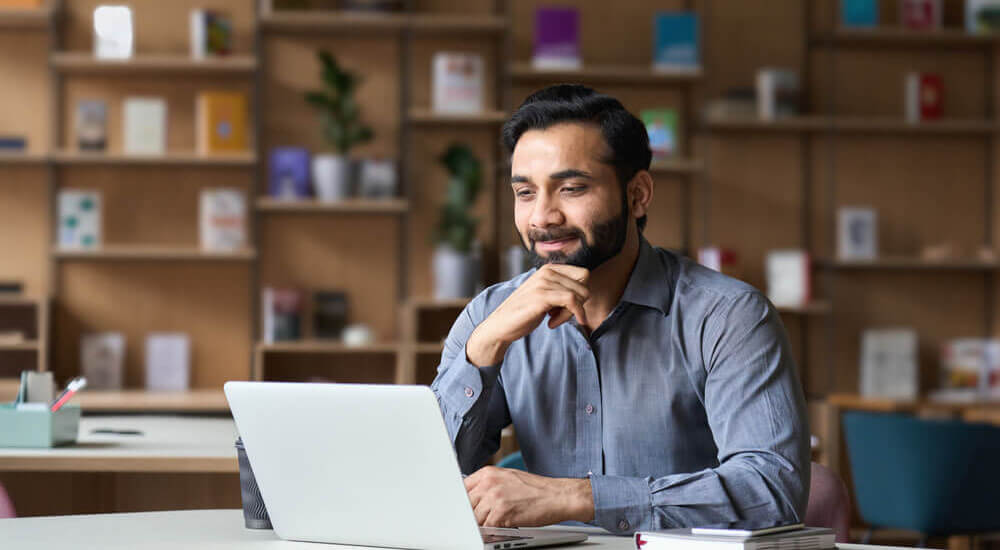 A man thinking in front of a laptop - Charleston County - Careers In Government