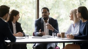 An African-american business leader talking during a team meeting
