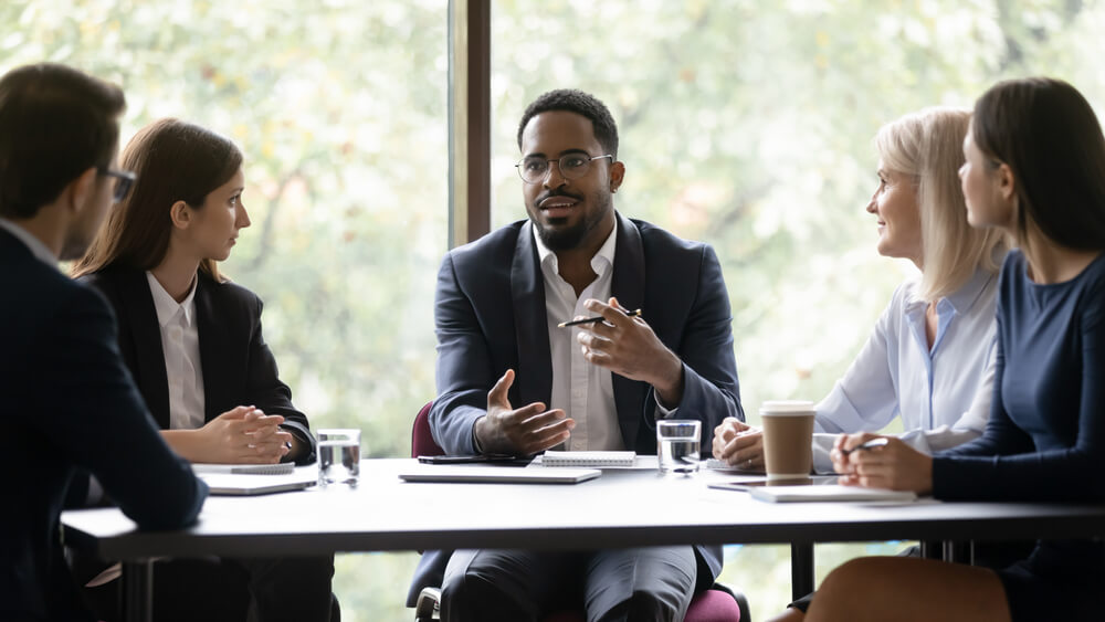 Engaged,Motivated,African,American,Business,Leader,Talking,To,Team,,Meeting