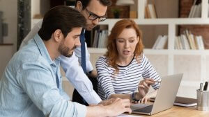 Smart young male supervisor reviewing the online sales report