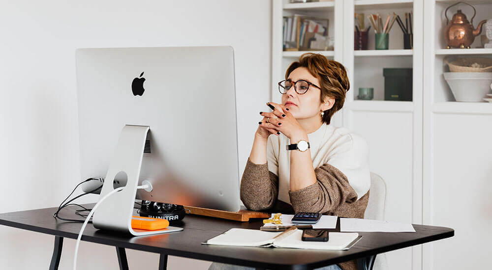 A lady staring at a desktop screen - Lexington County - Careers In Government