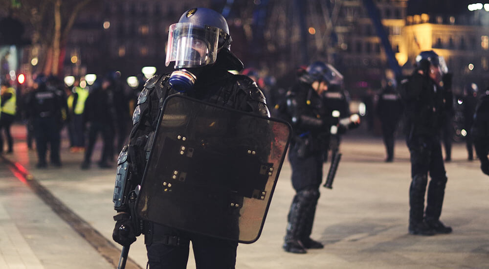 A police officer wearing riot gear - Harry Country - Careers In Government