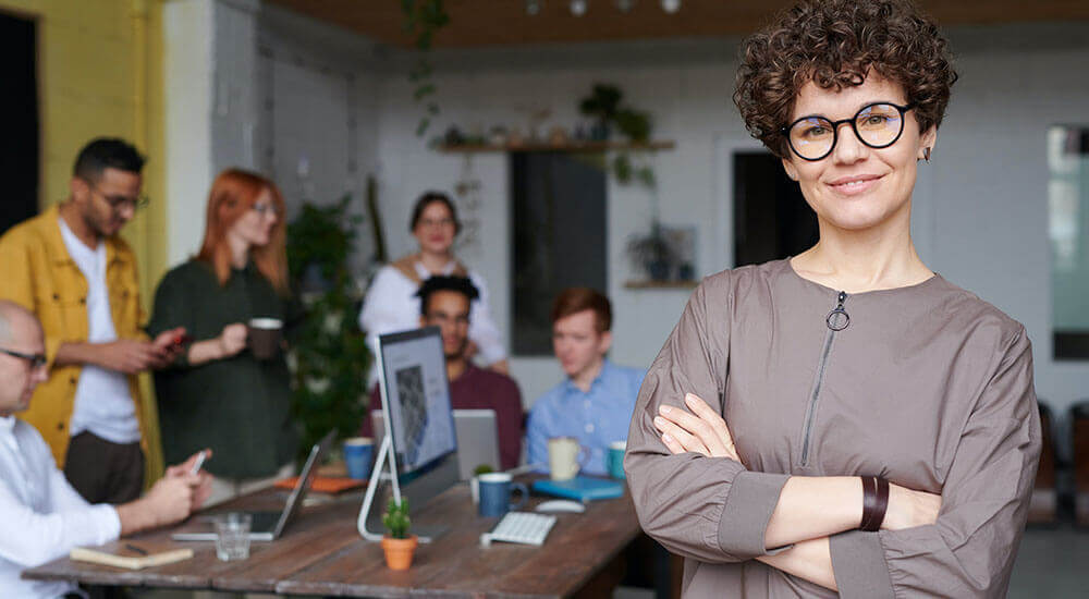 A woman folding her hands in front of her team - Spartanburg County - Careers In Government