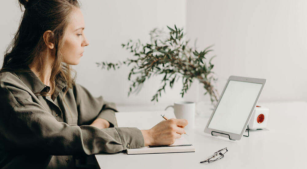 A woman looking at laptop screen - Lexington County - Careers In Government