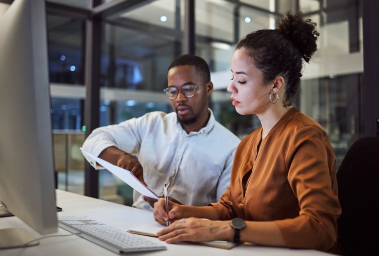 Team working on a document in a New York office at night