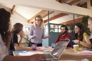 A female manager leading a team discussion and other listens