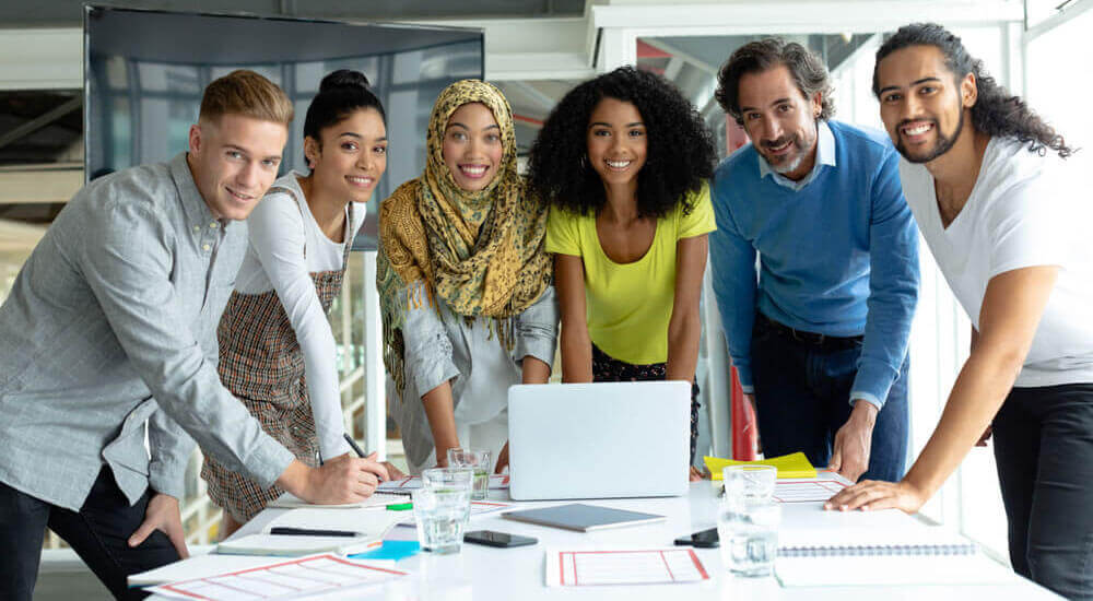 People gathering around a desk - Lexington County - Careers In Government