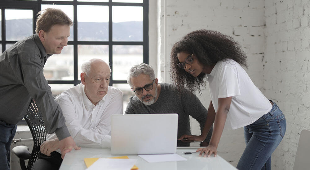 People staring at a laptop - Spartanburg County - Careers In Government