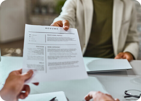 An applicant handing resume to an employer