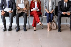 Individuals waiting for a job interview in a room