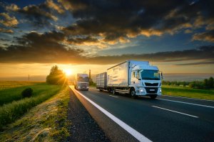 Overtaking trucks on an asphalt road in a rural ladscape