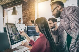 Three website design programmers working together