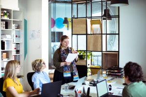 Young businesswoman presenting in front of colleagues