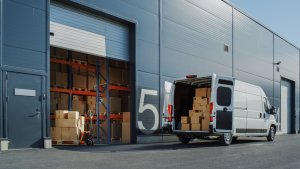 A logistic warehouse with a delivery van outside