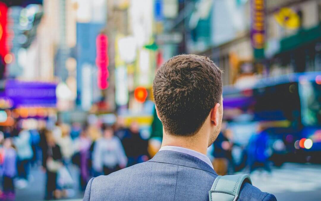 A man walking on the streets full of people