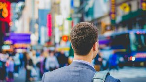 A man walking on the streets full of people