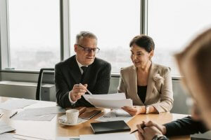 A Man and Woman checking Paper during a business meeting