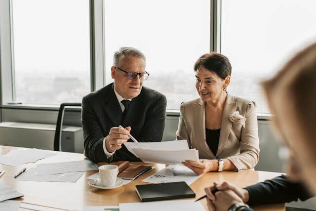 A Man and Woman checking Paper - Careers In Government