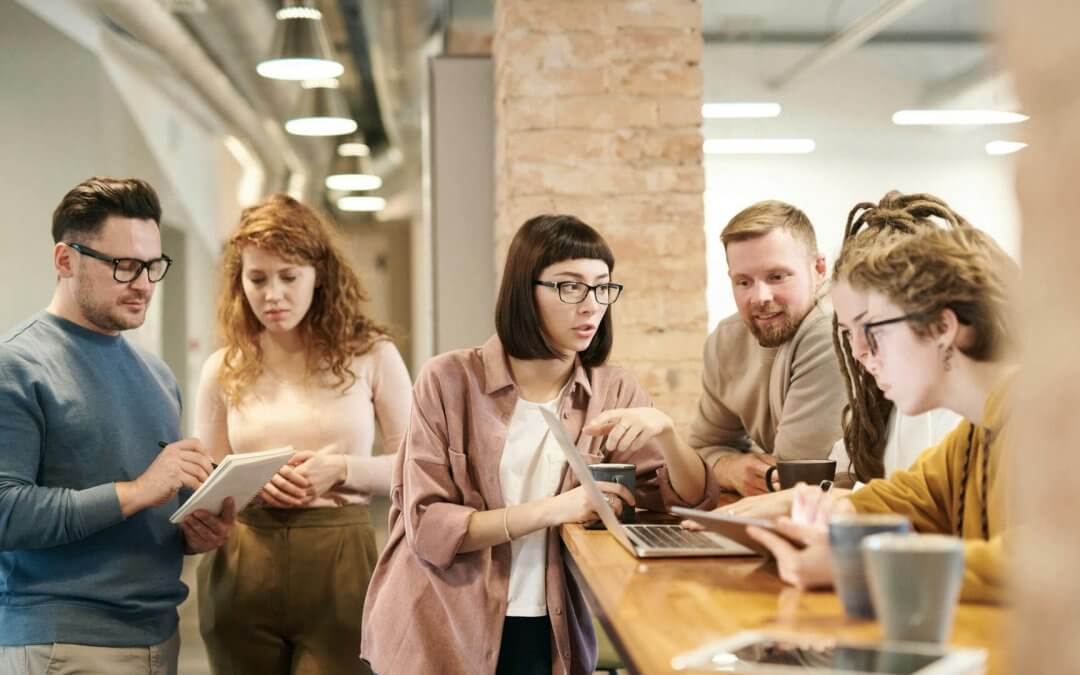 A group of people at office discussing during coffee break