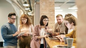 A group of people at office discussing during coffee break