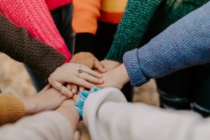 Children putting hands on top of each other