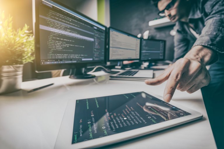 A man working on developing, programming, and coding