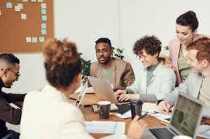 People working at the office happily discussing together