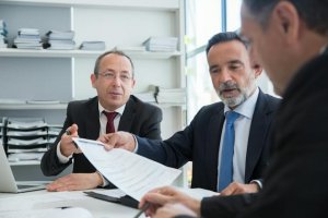 Three employers reviewing documents for Jobs