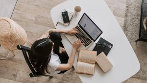 A Woman sitting and searching Job on Laptop