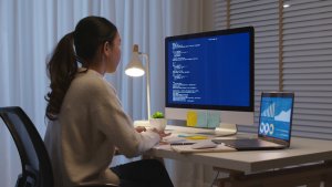 An Asian woman studying for MBA College late at night