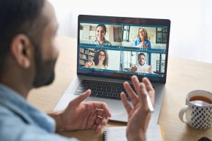 A Latin-Indian businessman having a virtual meeting with his team