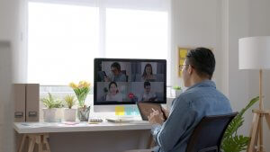 Asian people utilizing video call during an online meeting