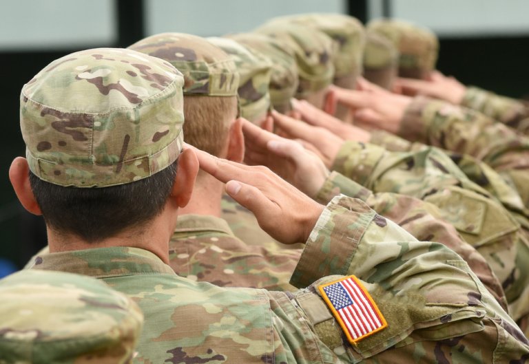 American soldiers lined up, giving a salute
