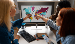 Women pointing places in the map while a man watching them choose