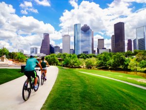 Bike riding in a park with views of buildings and nature