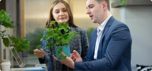 Employee analyzing a plant's health in an office