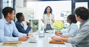 A group of employees receiving feedback on their campaign project