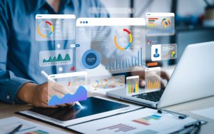 An analyst uses a computer and dashboard for business data