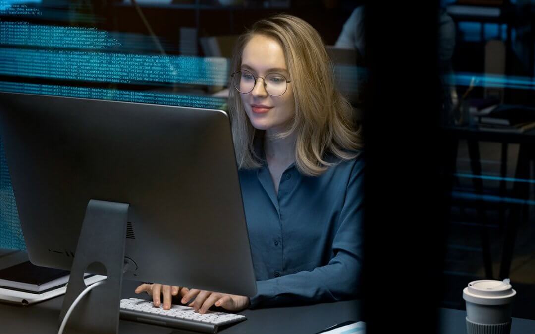A software engineer using her personal computer to do coding